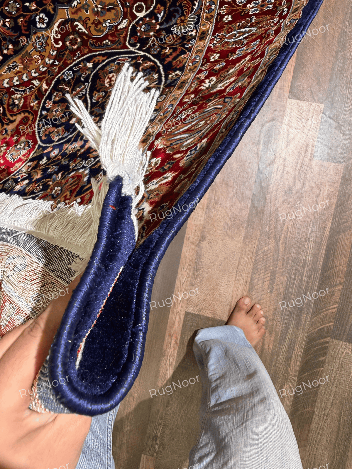 Ivory fringe and navy finished edge on the folded Jouri traditional rug - RugNoor