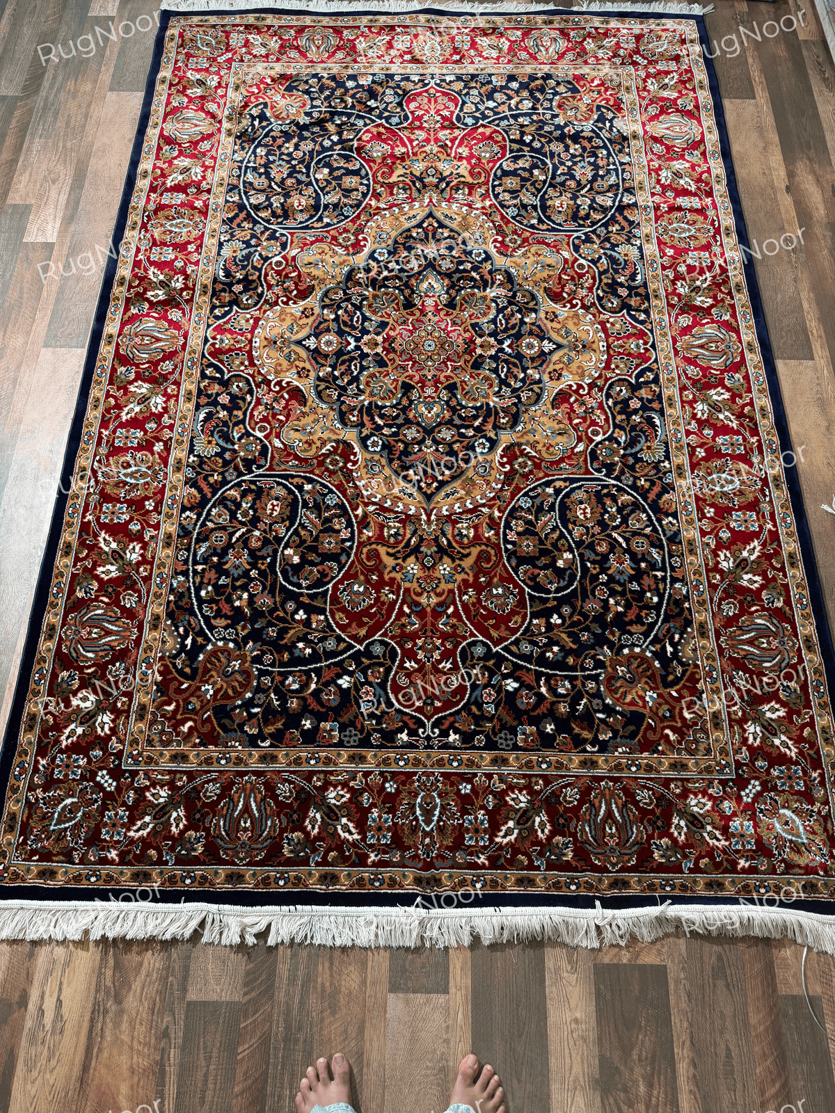 Traditional Jouri rug with ornate gold medallion, navy field and red floral border - RugNoor