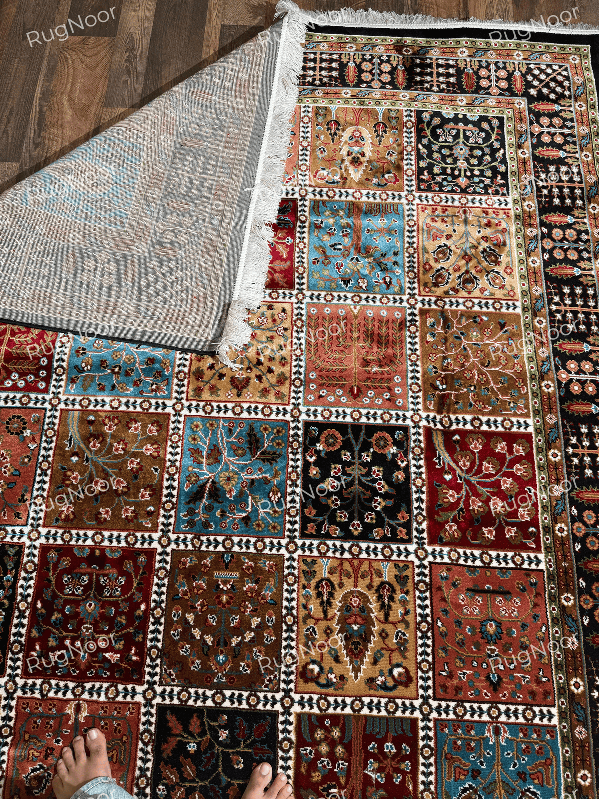 Folded patchwork rug showing its patterned backing and ivory fringe - Kashida RugNoor
