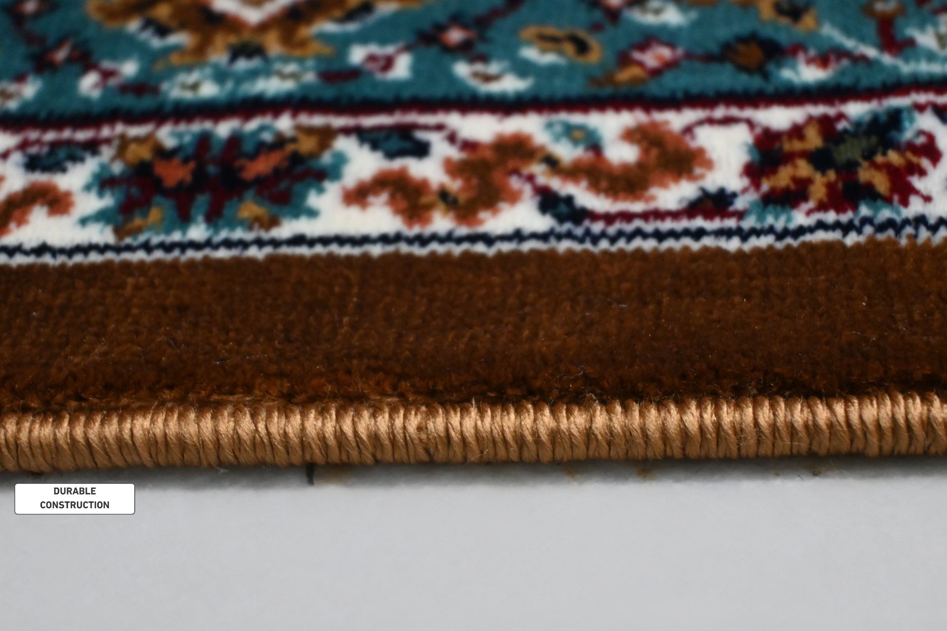 Side edge of Naqsh Persian rug showing durable woven backing and reinforced bound edge construction