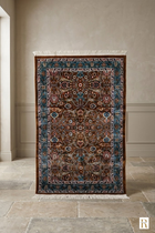 Naqsh Persian rug full view — warm brown base with deep teal border, all-over floral arabesque pattern and ivory cotton fringe