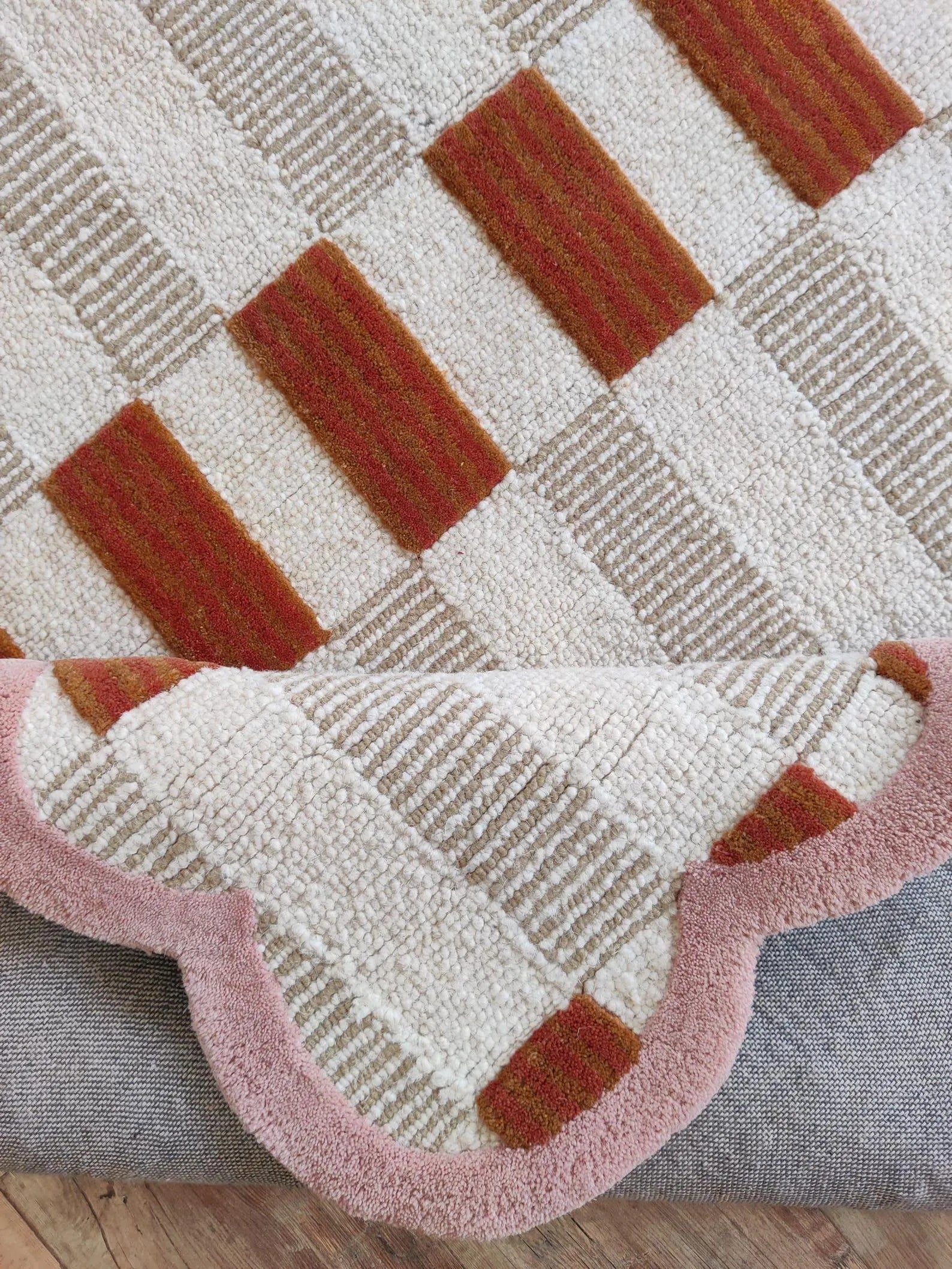 closeup of pink scalloped rug carpet