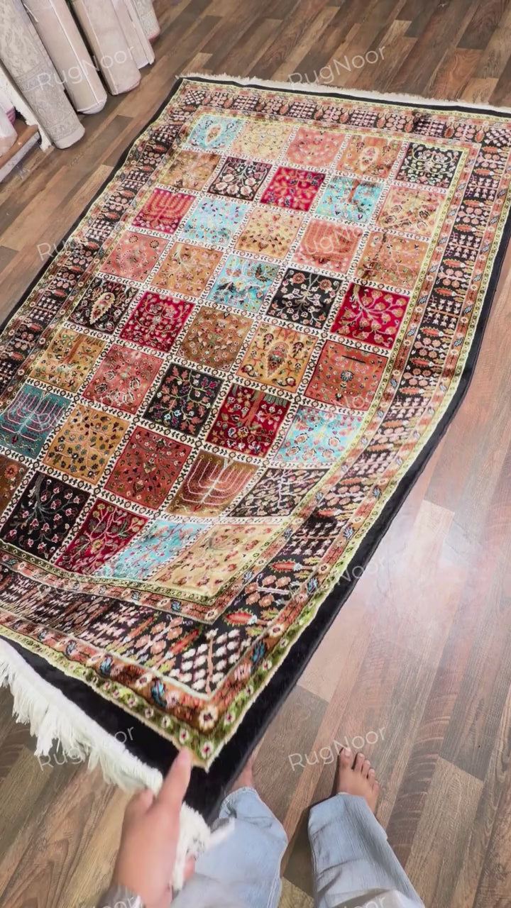 Folded patchwork rug showing its patterned backing and ivory fringe - Kashida RugNoor