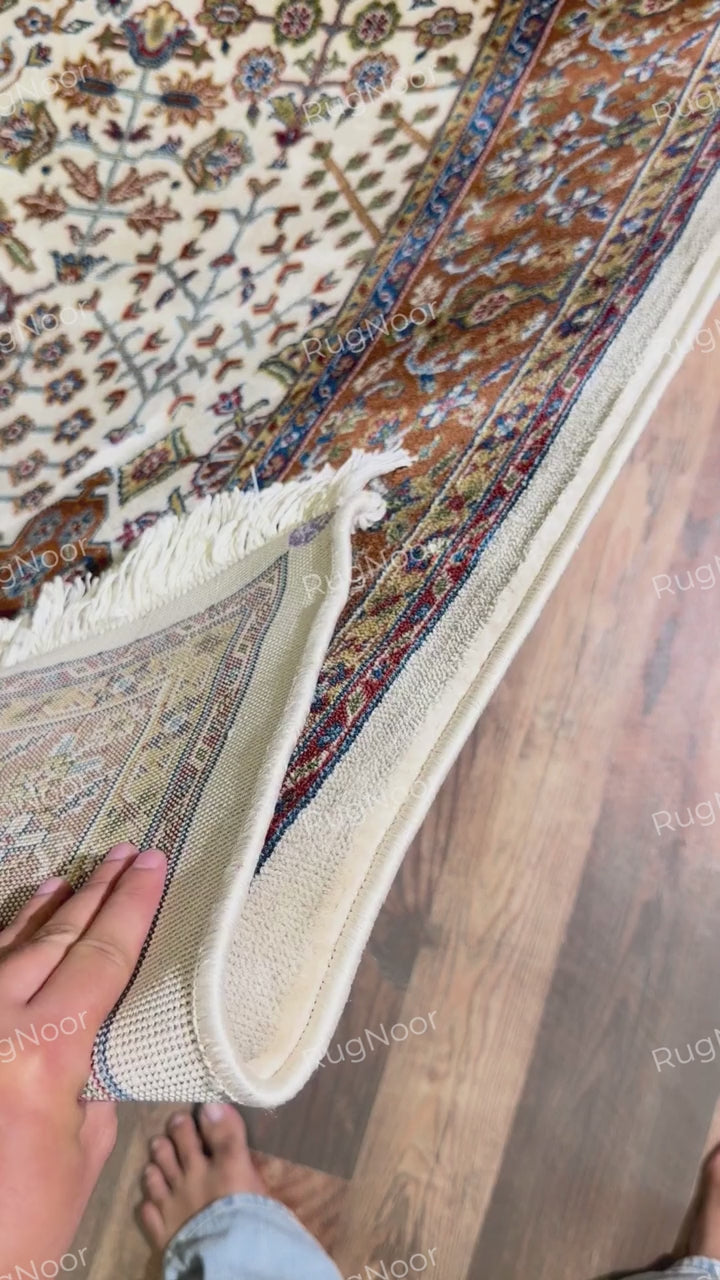 Close-up of rust-brown ornamental border with navy, ivory and gold floral details - Ghazal RugNoor