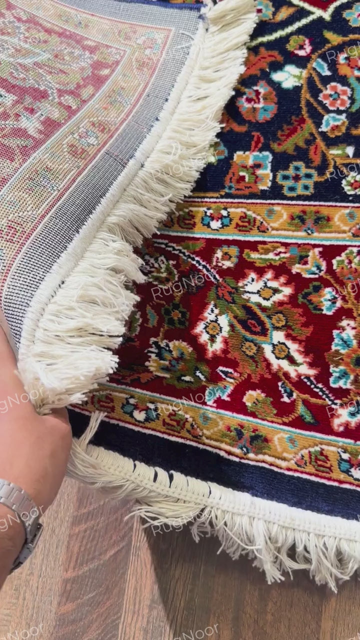 Red floral border with gold, ivory, teal and navy motifs on Jouri rug and its backing - RugNoor