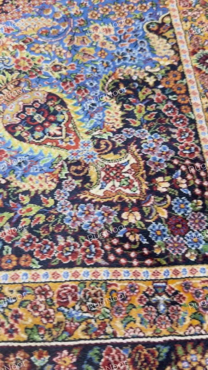 Close-up of the carpet's intricate floral border in cream, rust, gold, and blue with fringed edging by RugNoor