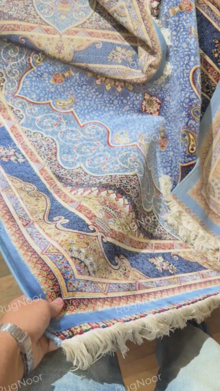 Yasamin rug underside showing its blue backing and patterned border.