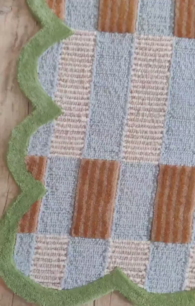 closeup of sage green checkered rug carpet