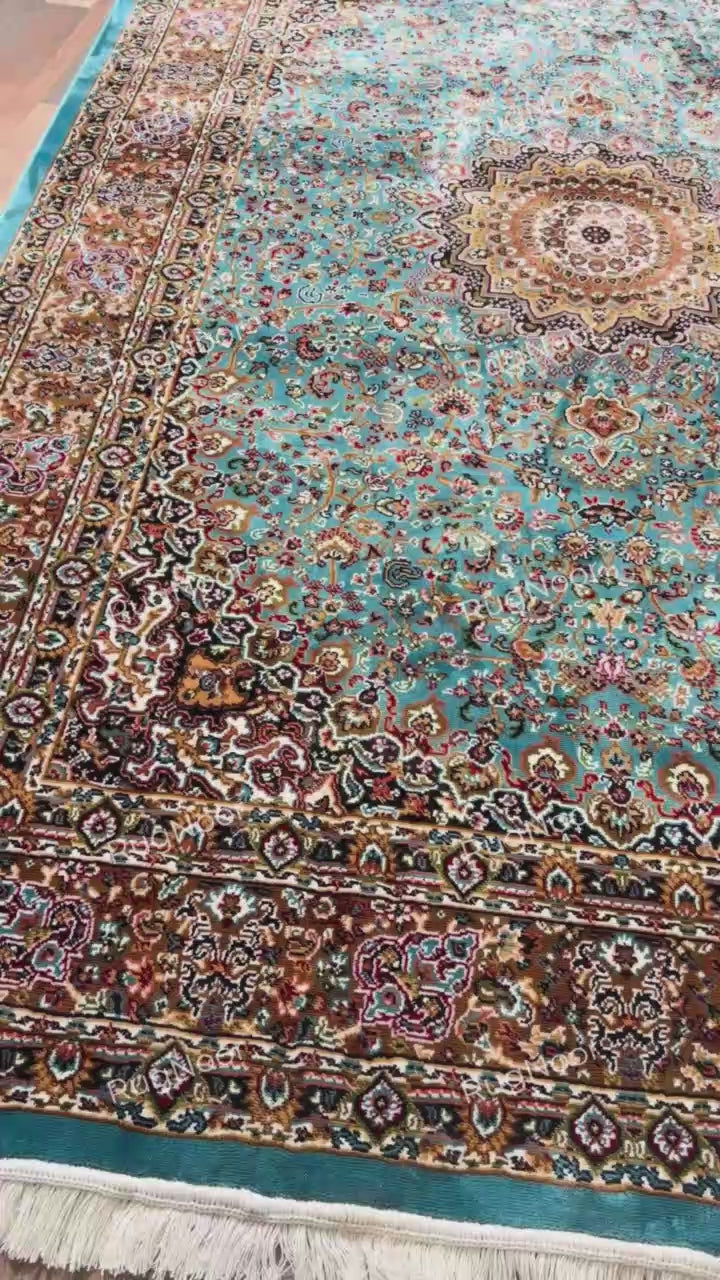 Turquoise traditional rug with ornate floral medallion, dark borders and ivory fringe - Zukhruf RugNoor