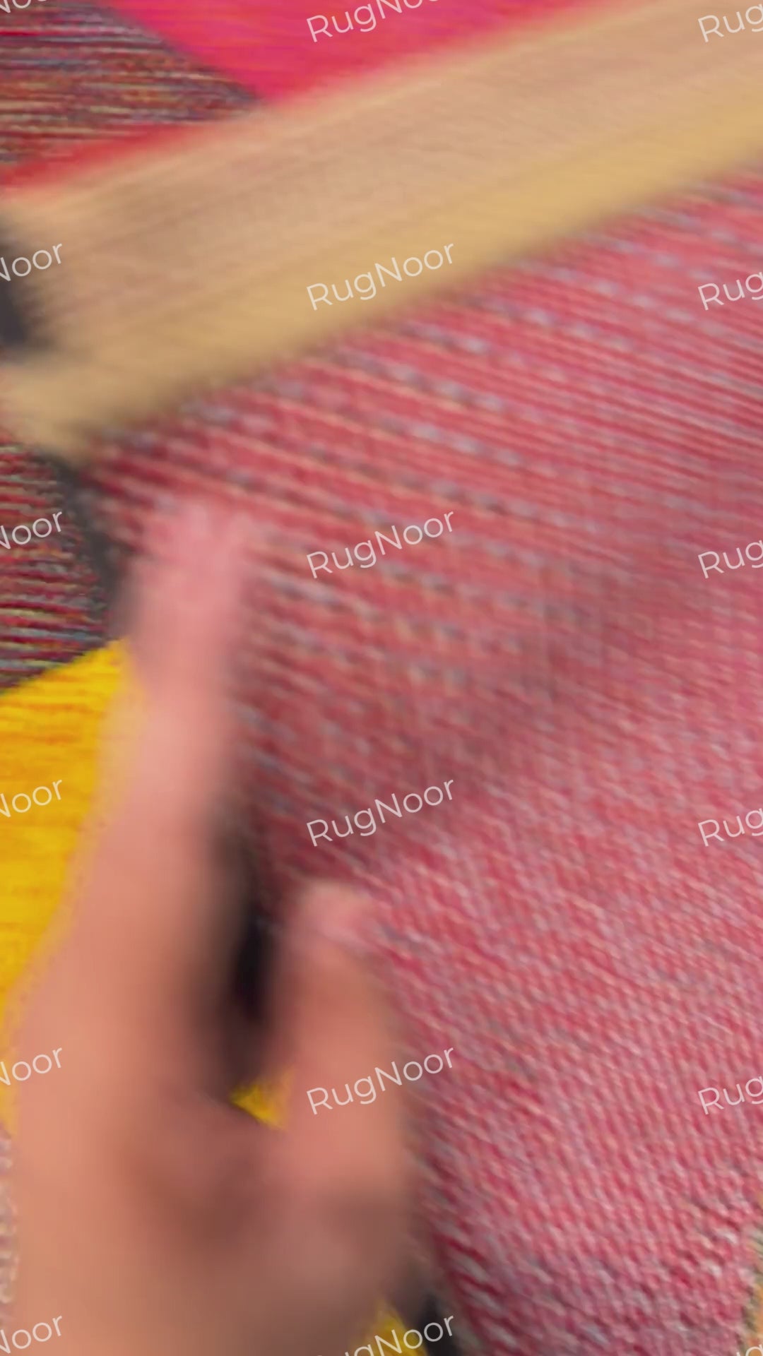 Underside of the Prismland carpet showing its woven backing, bound edge,
