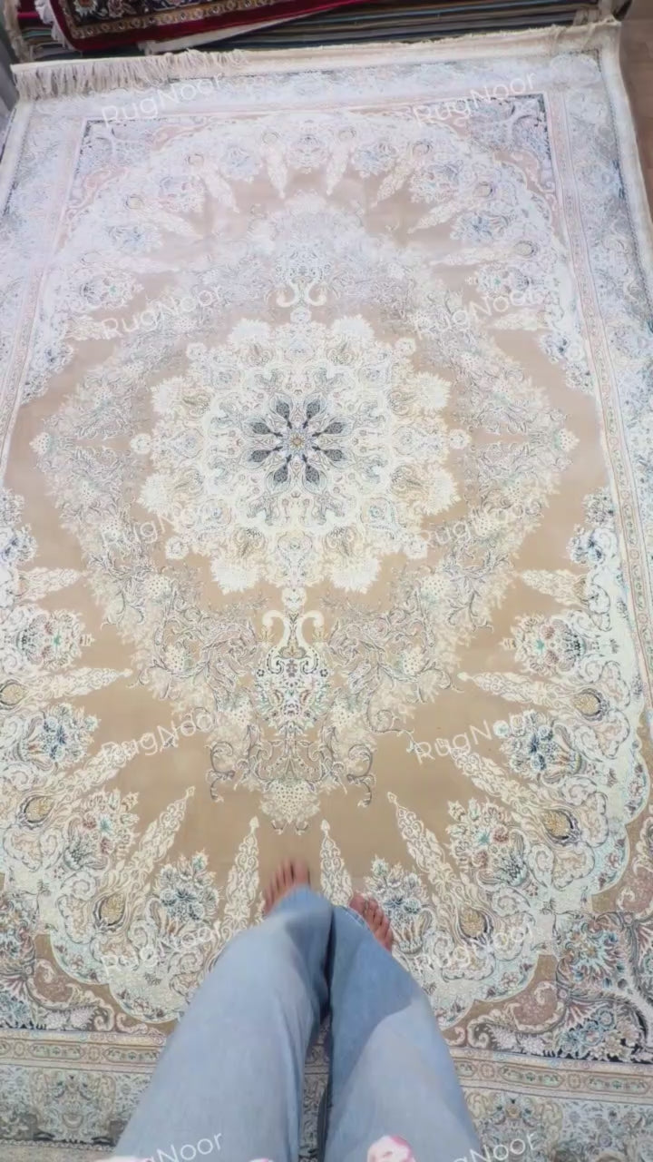 Warda's central medallion and surrounding scrolling floral motifs across the beige carpet field, RugNoor.