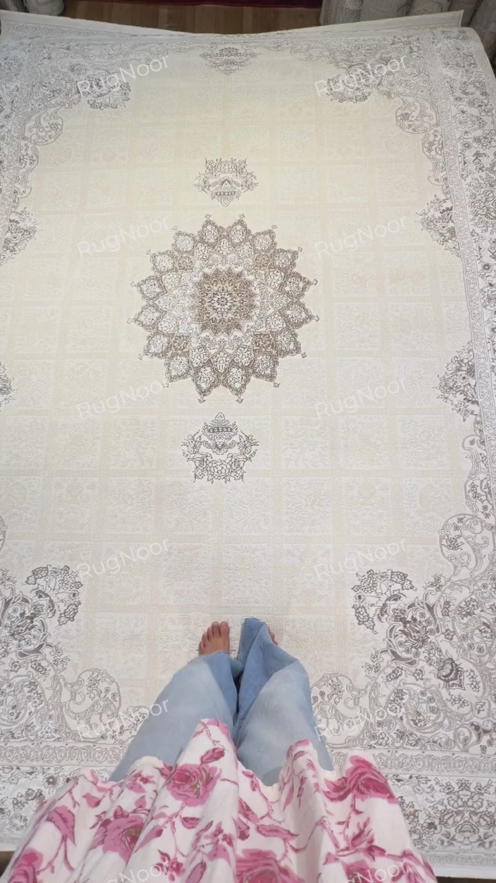 full view of Parichehr showing its ivory patchwork field, central medallion and detailed perimeter border, RugNoor.