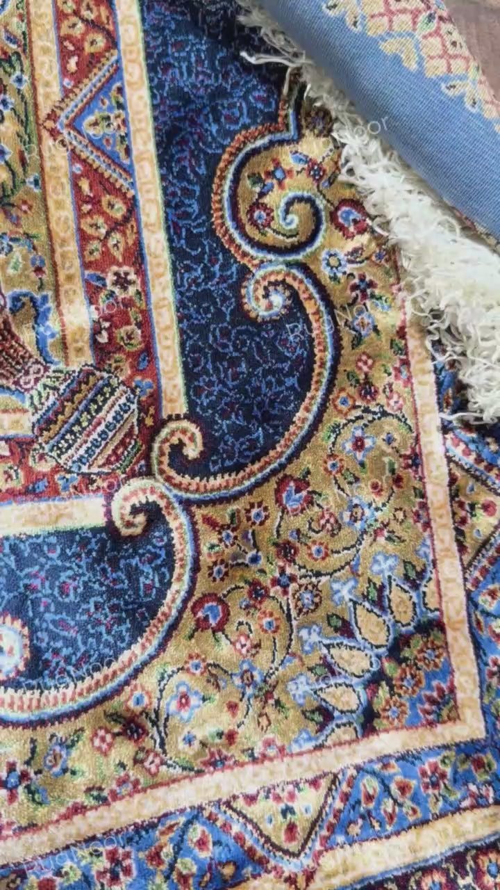 Close-up of Yasamin's navy floral border with ivory, rust, and gold accents.