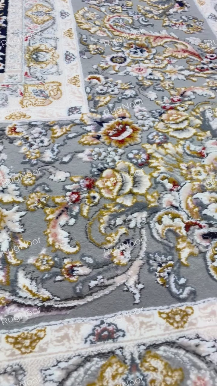 Close-up of Urkeed's scrolling floral vines, ivory blossoms and grey ornamental shapes against a beige field, RugNoor.