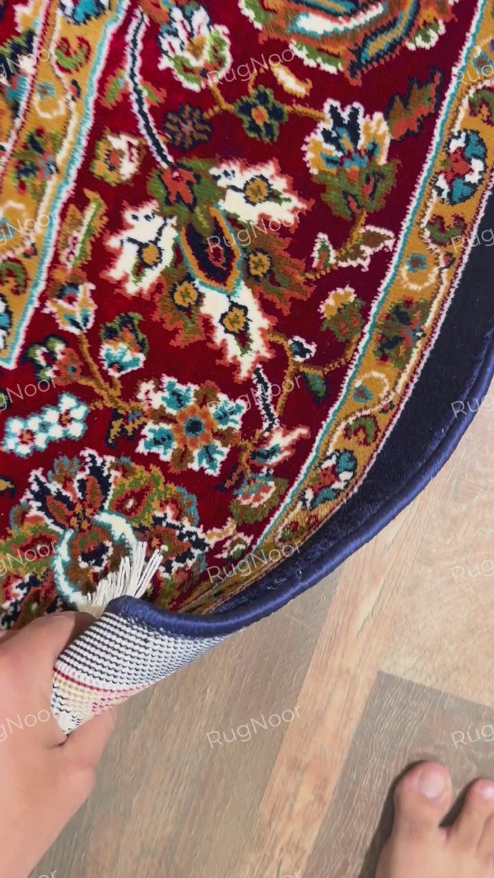Folded Jouri rug edge showing navy binding, pile and finished border - RugNoor