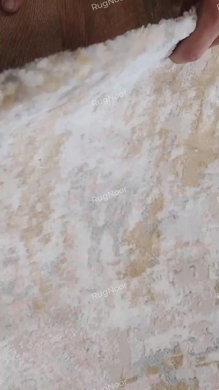 Video demonstrating the Crossfade rug's lifted corner, surface pile and appearance underfoot as a person walks across it.
