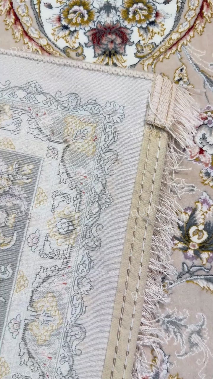 Folded corner of Urkeed rug, revealing the carpet's underside alongside its beige floral surface, RugNoor.