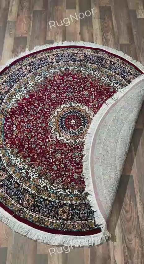 Folded Yaqut round traditional rug showing its patterned underside, burgundy surface and ivory fringe - RugNoor