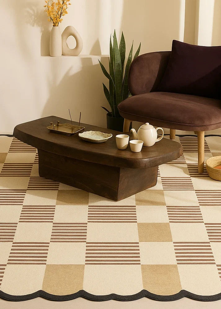 Ivory and brown checkerboard hand-tufted rug with scalloped black edge styled in a modern living room with wooden coffee table