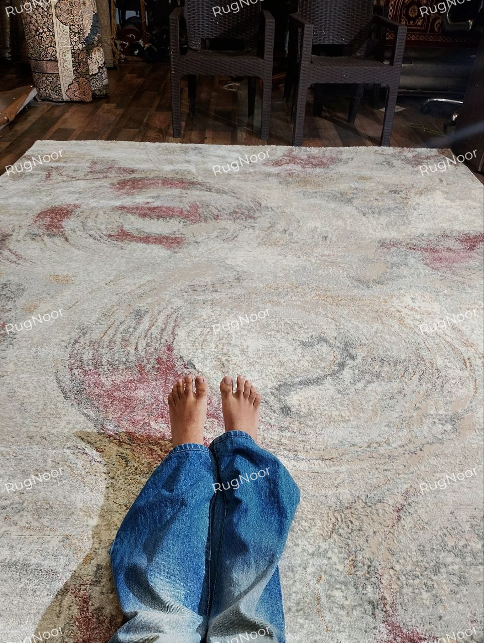 Close-up of the dusty rose section of the Rovelle rug showing its distressed circular pattern and surface texture.
