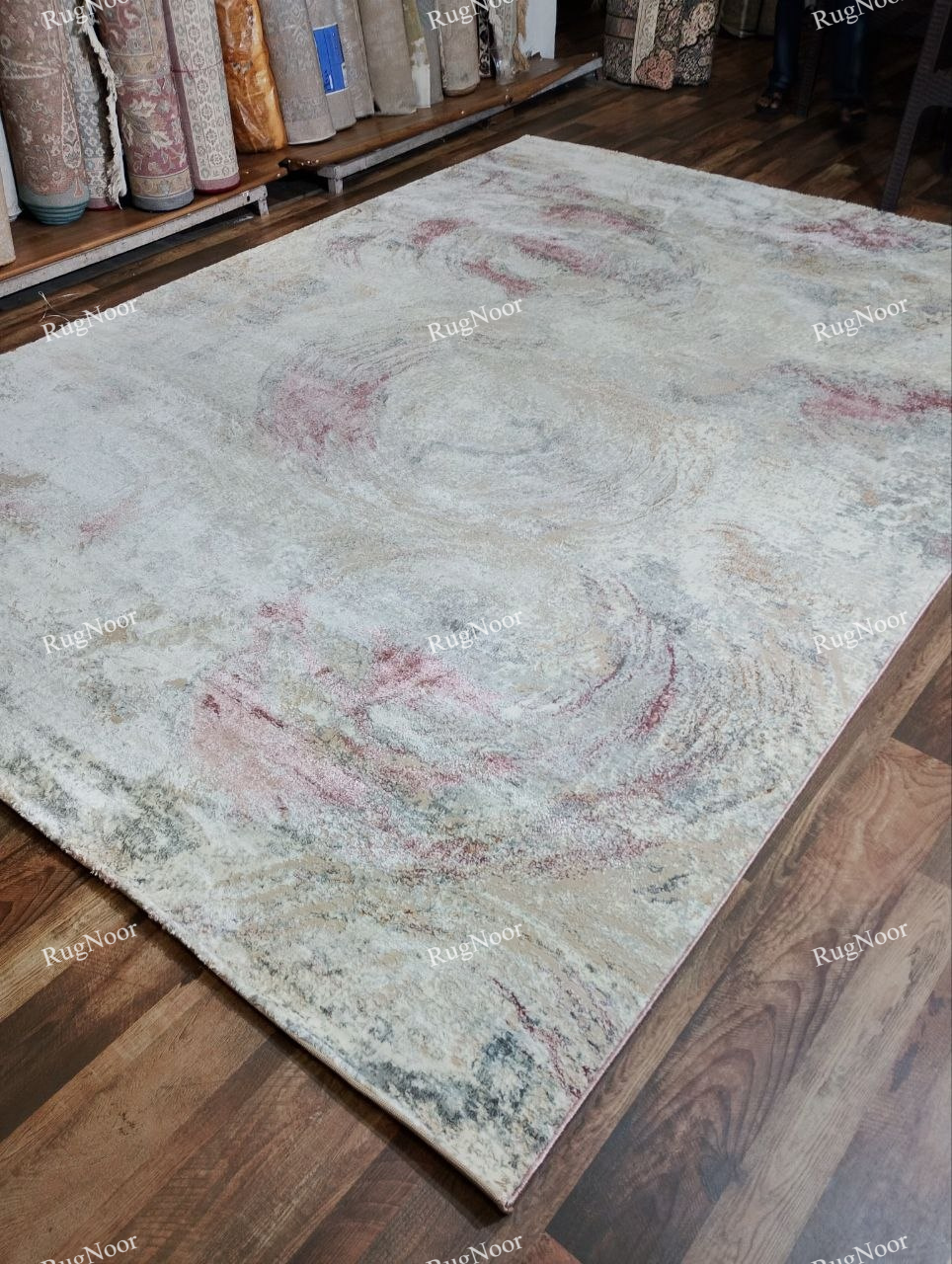 Side-angle view of the Rovelle abstract rug showing its surface texture, pile and finished edge.