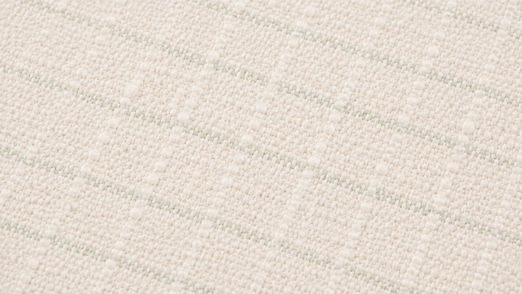 A close-up of a textured swatch in a warm off-white or cream color, featuring a subtle woven pattern of diagonal light green stripes.