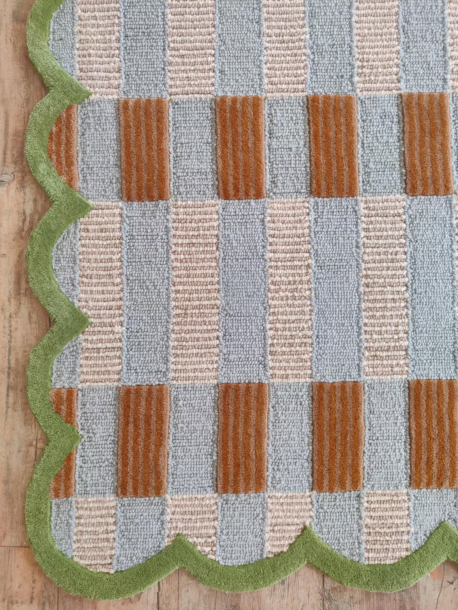 Textured rug with a checkered pattern on a wooden floor