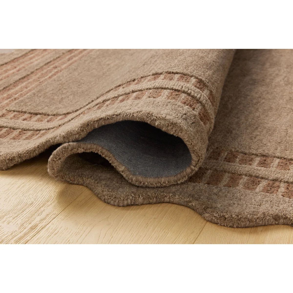 Brown textured rug on a wooden floor