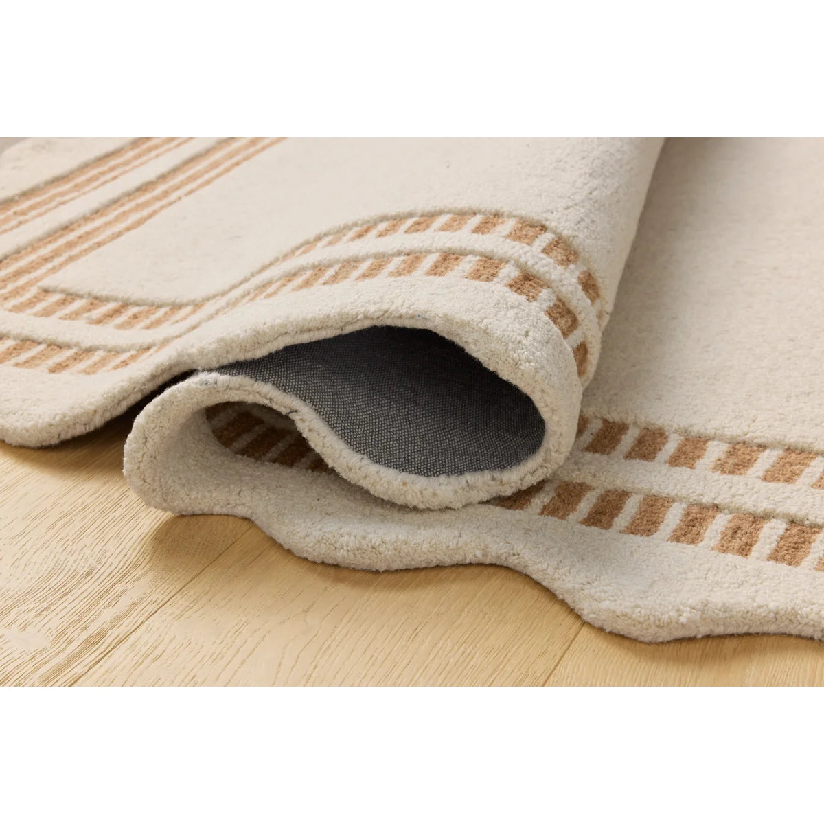 Beige rug with brown stripes on a wooden floor