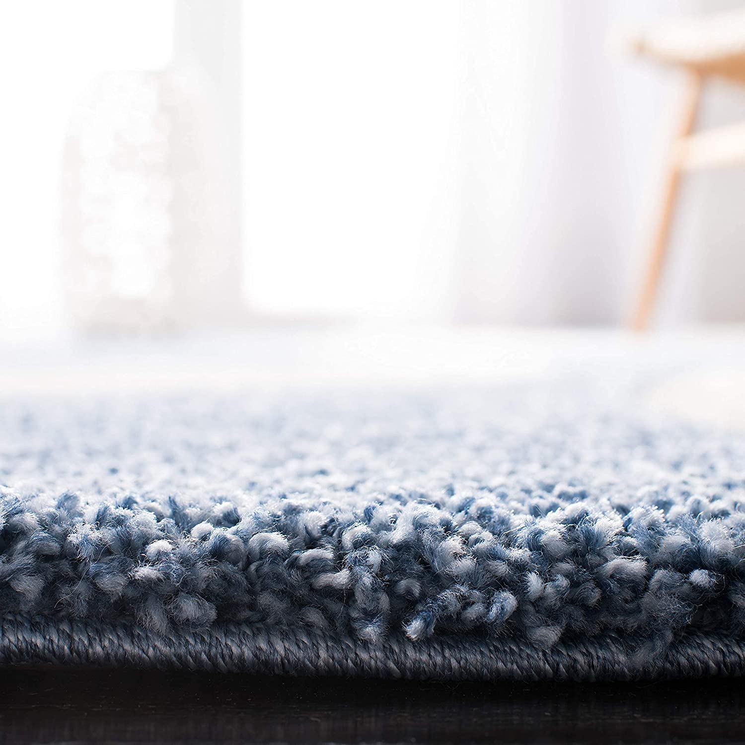 Close-up of a blue textured rug with a blurred background