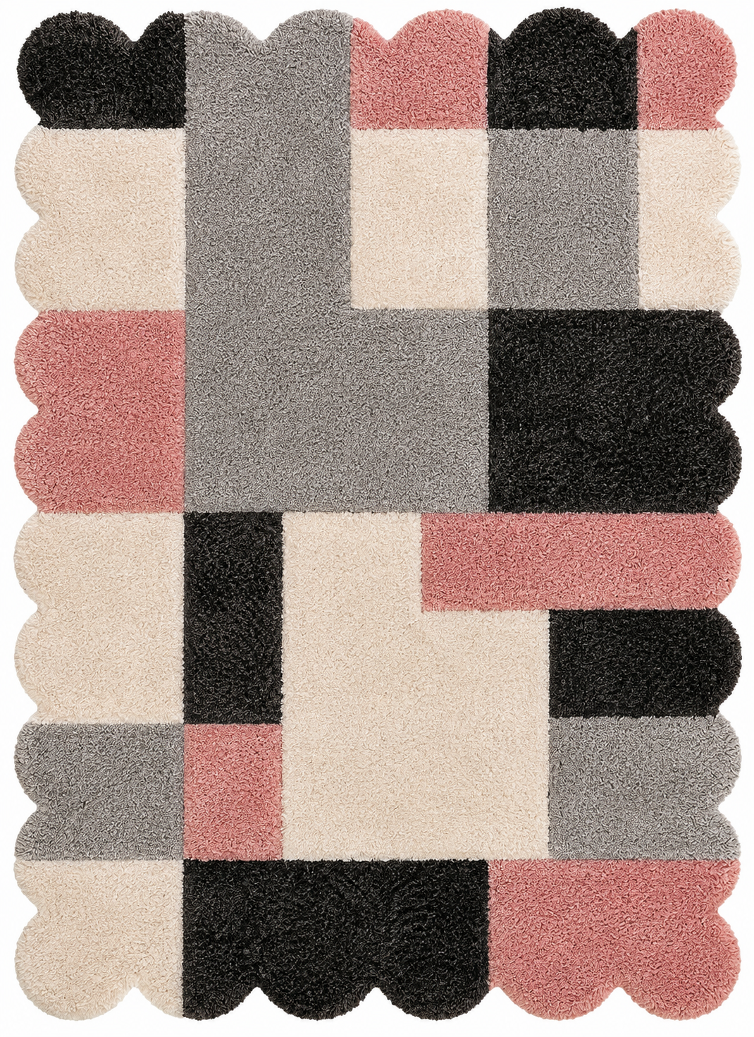 A rectangular shag rug with scalloped edges featuring a geometric patchwork pattern in black, gray, beige, and dusty pink on a white background.