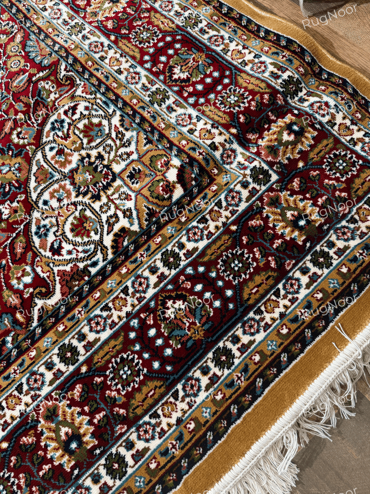 Close-up of mustard gold floral field and ornate burgundy, cream and navy border - Shams RugNoor