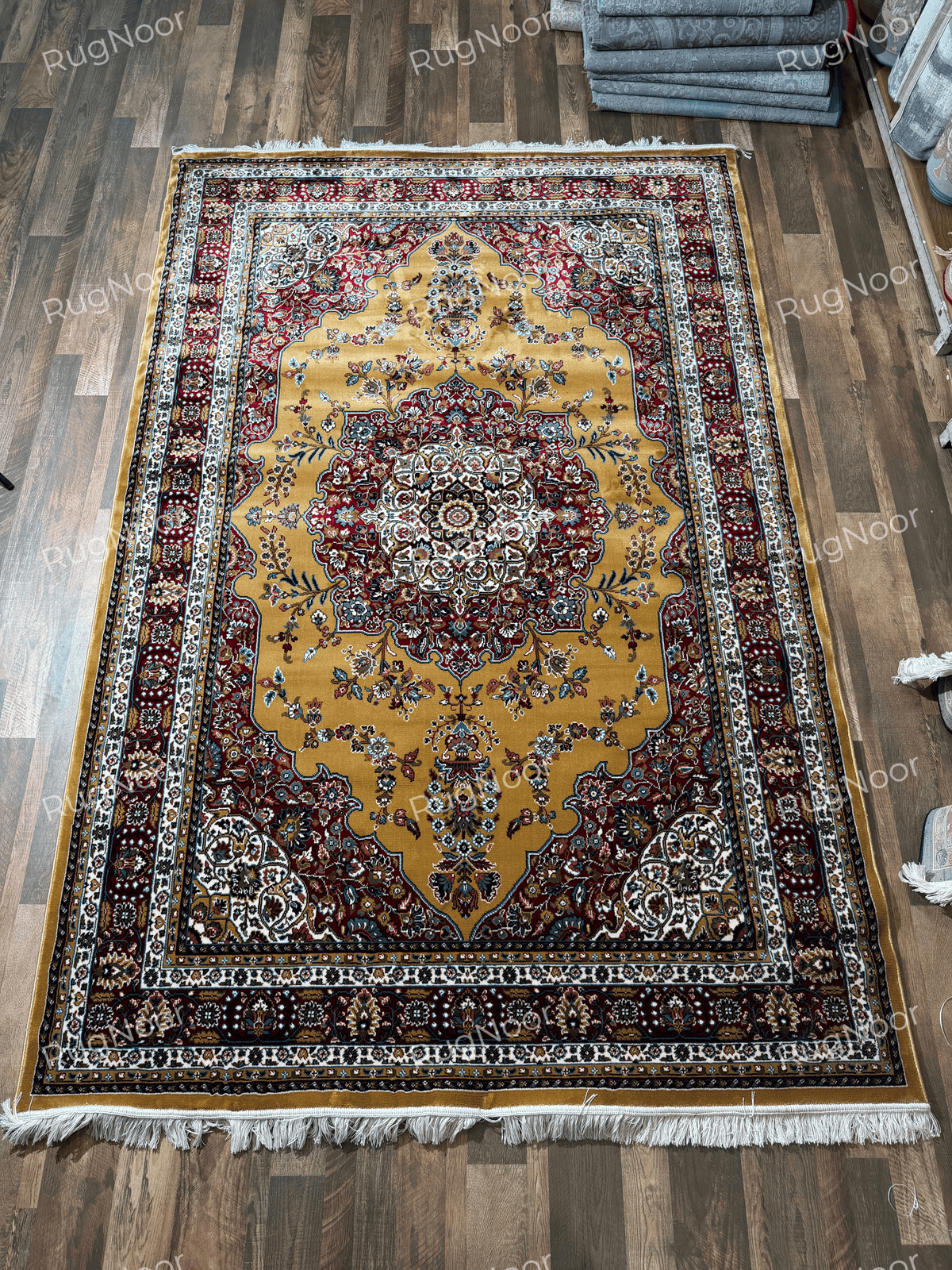 Full view of mustard gold rug with ornate burgundy medallion, floral motifs and ivory fringe - Shams RugNoor