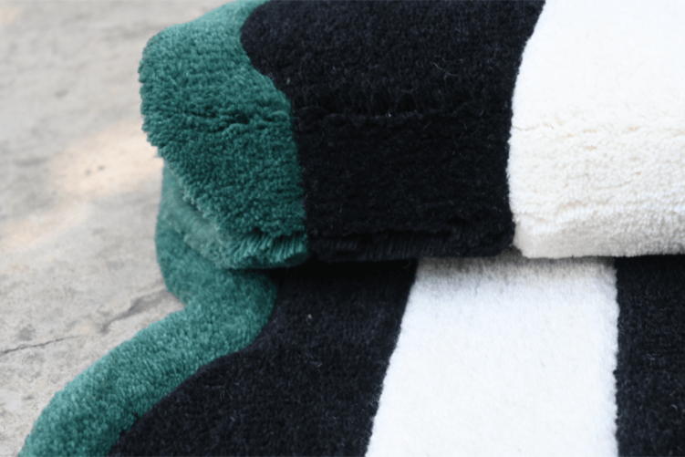 Hand-tufted green, black and white striped rug – folded edge close-up, RugNoor