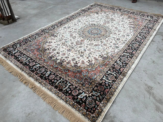 Toranj Royal Medallion Rug laid on a concrete floor showing the full medallion design, layered borders and fringe