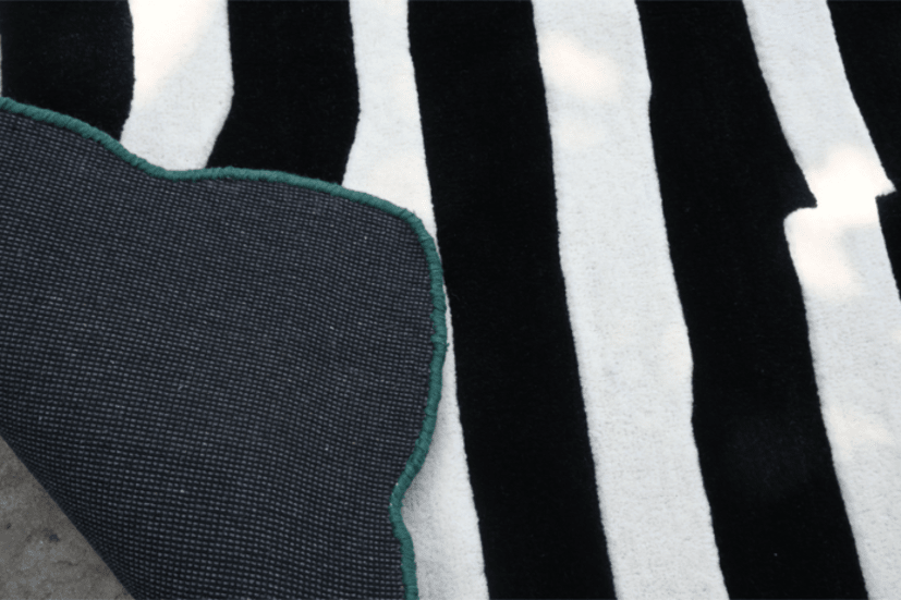 Black and white striped rug with canvas backing – corner close-up, RugNoor
