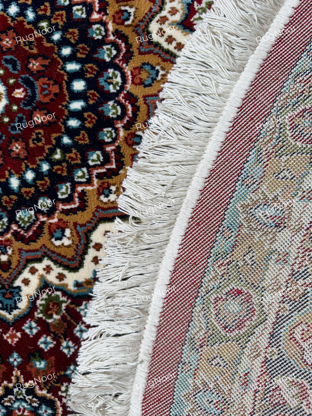 Close-up of Yaqut rug's burgundy outer edge, intricate woven border and ivory fringe - RugNoor