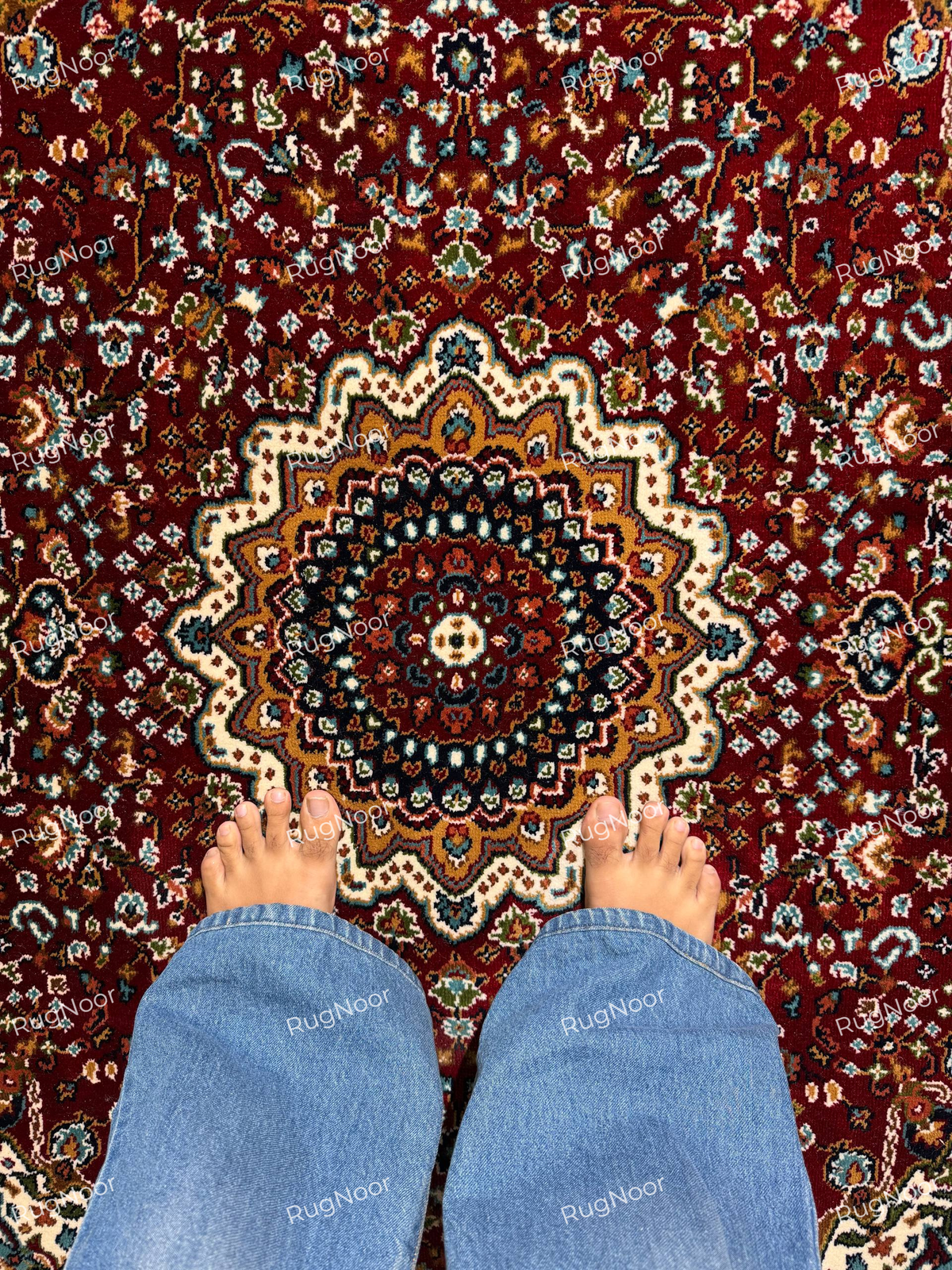 Close-up of Yaqut rug's ivory central medallion surrounded by burgundy, teal, gold and cream floral motifs - RugNoor