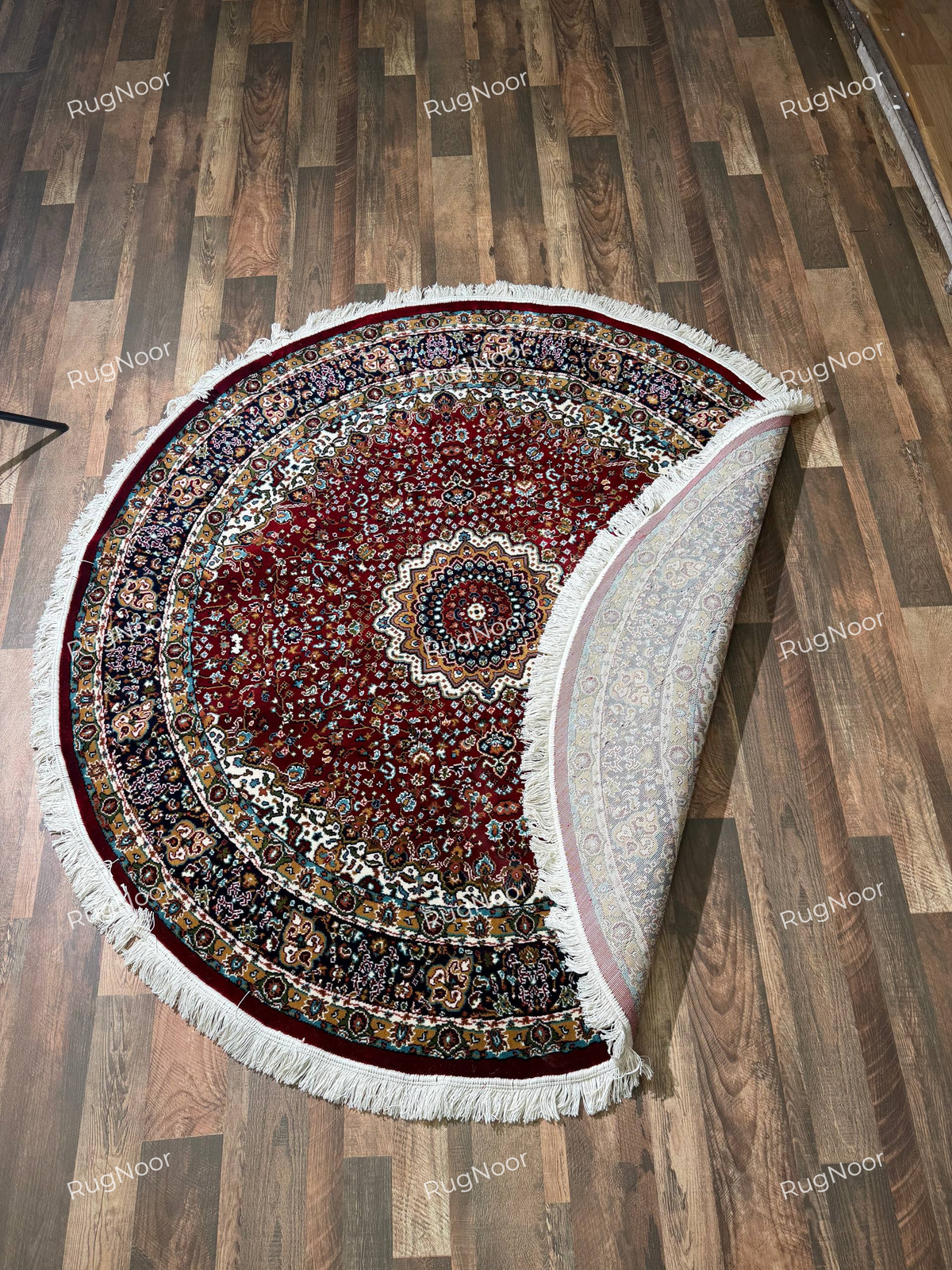 Yaqut round rug showing its multicolour floral border, ivory fringe and patterned backing - RugNoor