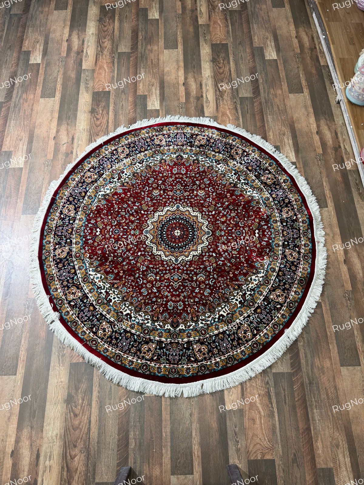 Full view of Yaqut round burgundy rug with dense floral detailing, layered ornamental borders and ivory fringe - RugNoor