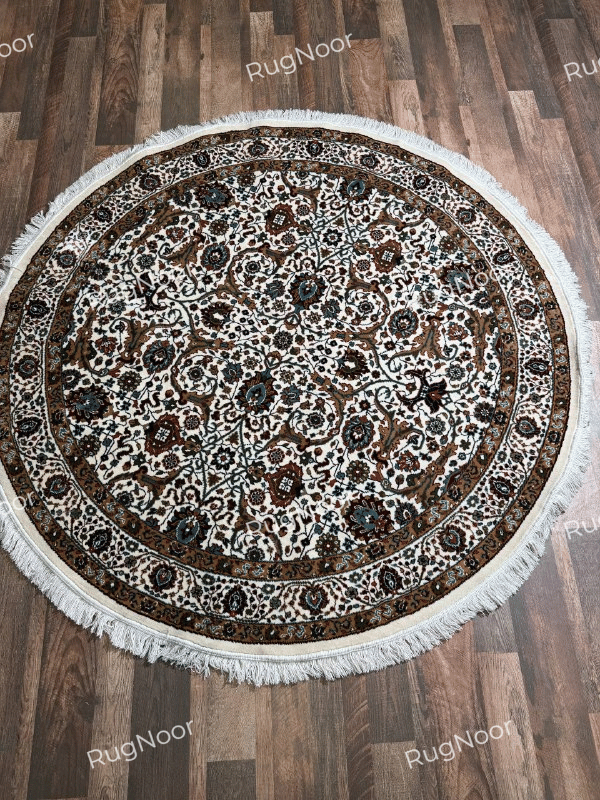 Zarqaya round Persian-inspired floral rug featuring an ivory field, intricate multicolour motifs, brown decorative borders and fringe - RugNoor