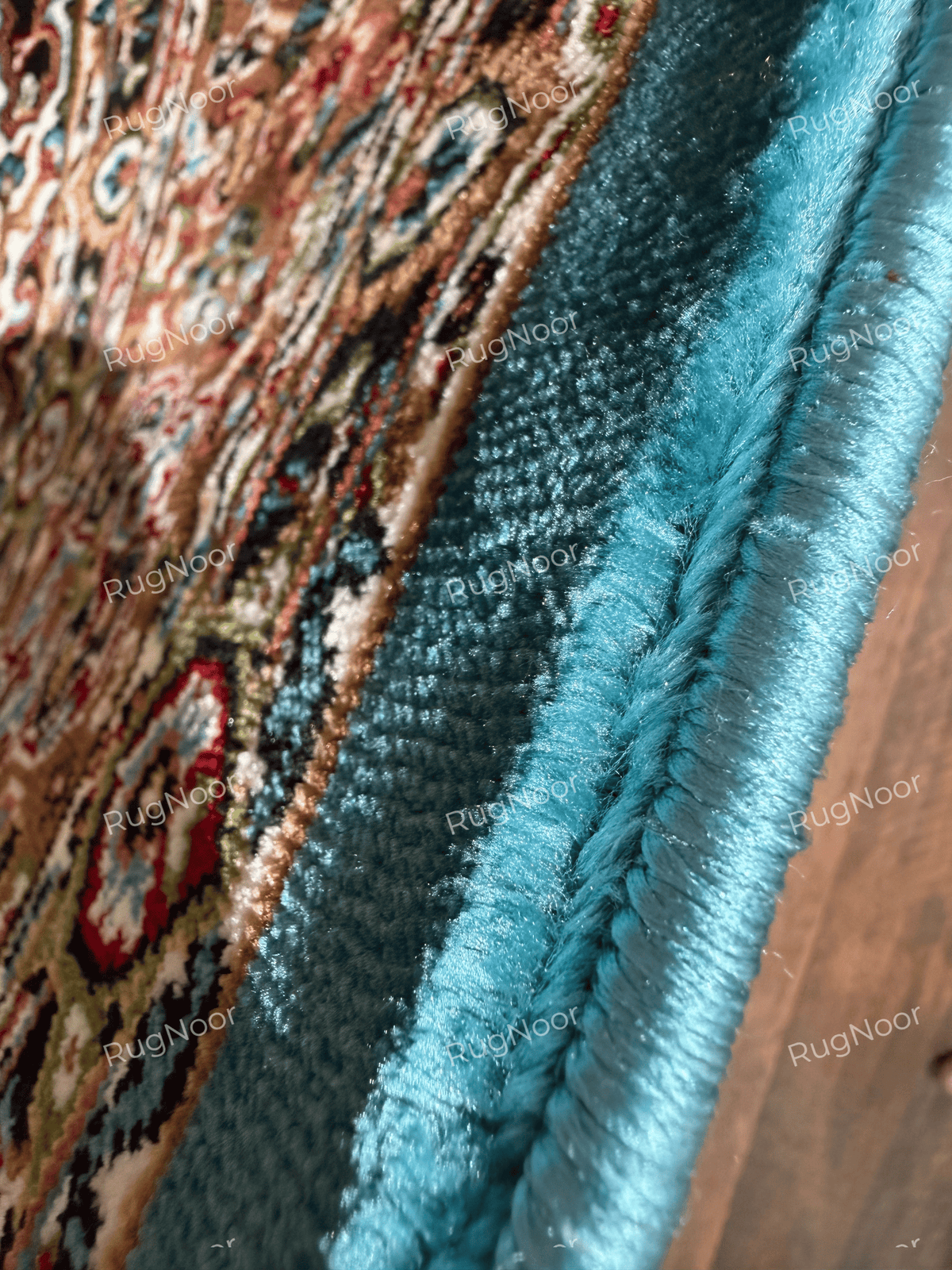 Close-up of turquoise edge binding and carpet pile along the rug's outer edge - Zukhruf RugNoor