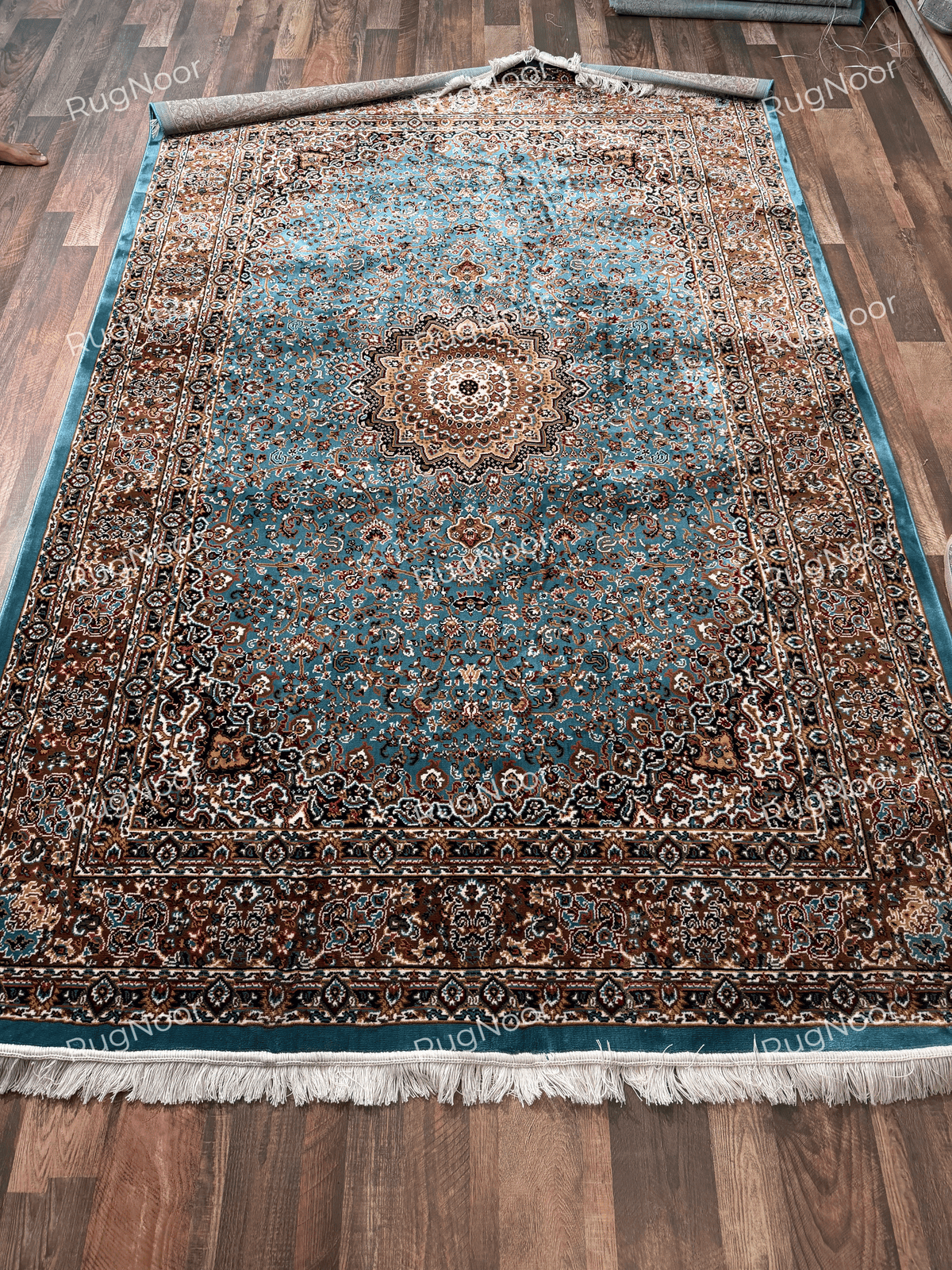 Full view of turquoise rug with cream-gold medallion and multicolour floral borders - Zukhruf RugNoor