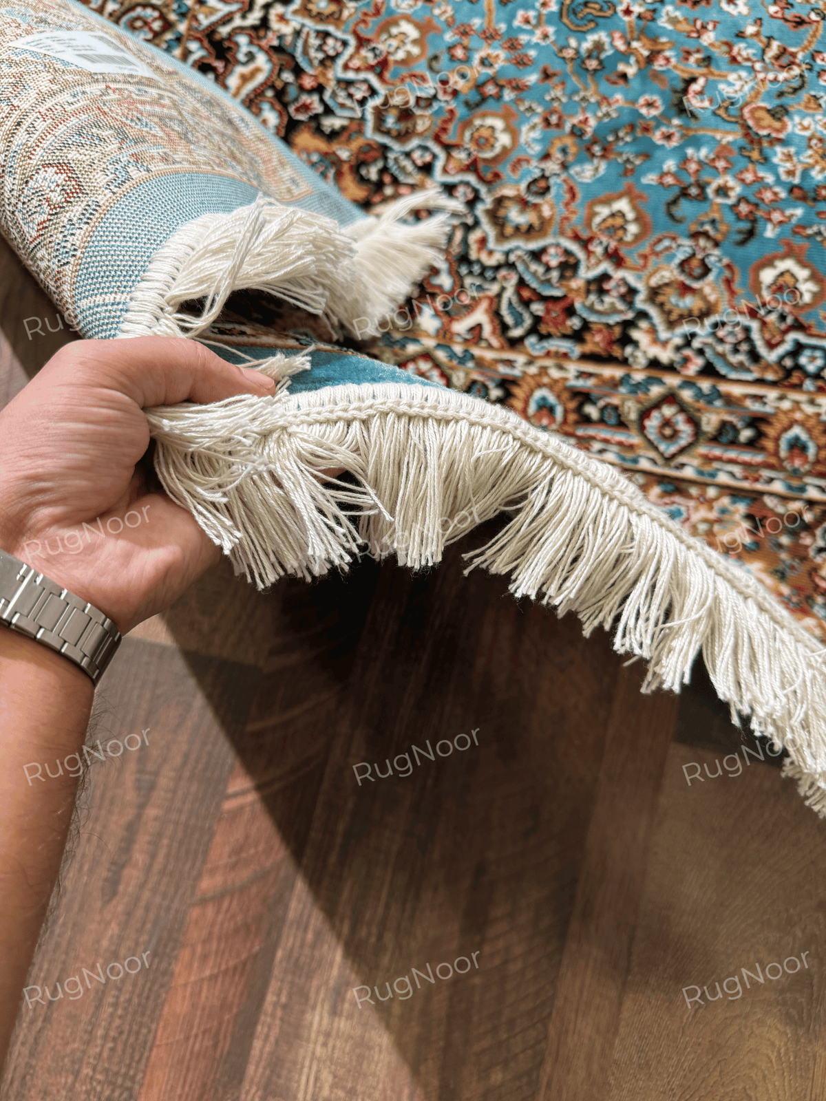 Close-up of ivory fringe and turquoise binding on the edge of the traditional rug - Zukhruf RugNoor
