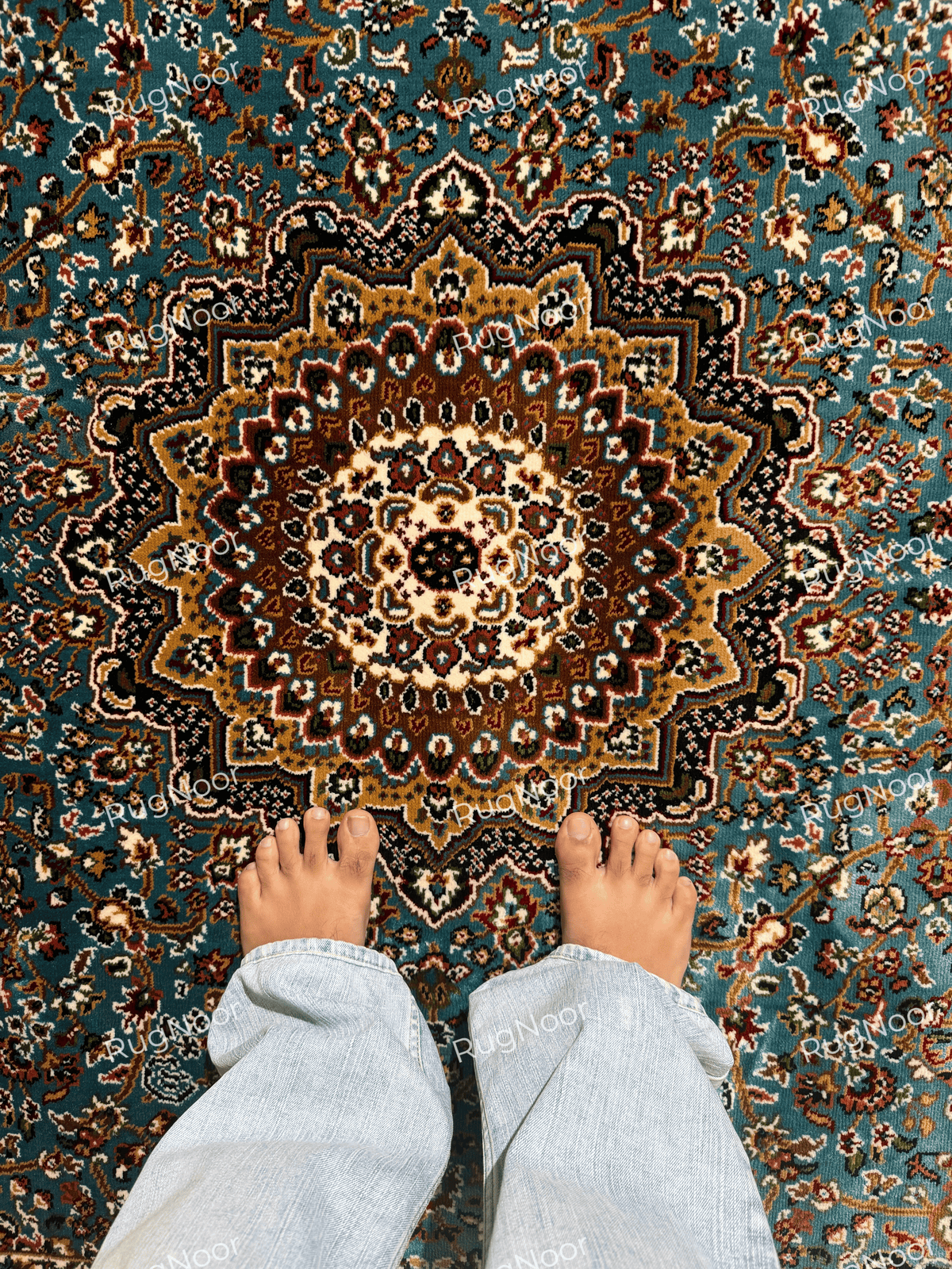 Close-up of the rug's ornate cream and gold central medallion on a turquoise floral field - Zukhruf RugNoor