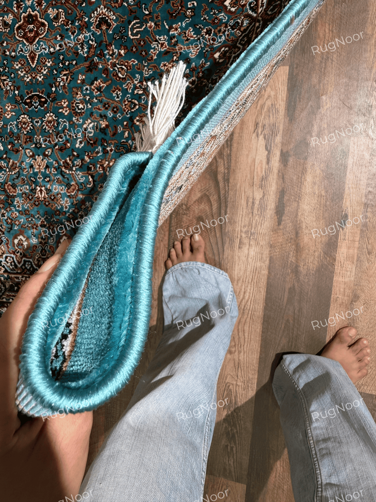 Folded rug edge showing turquoise binding, pile and the thickness of the carpet - Zukhruf RugNoor