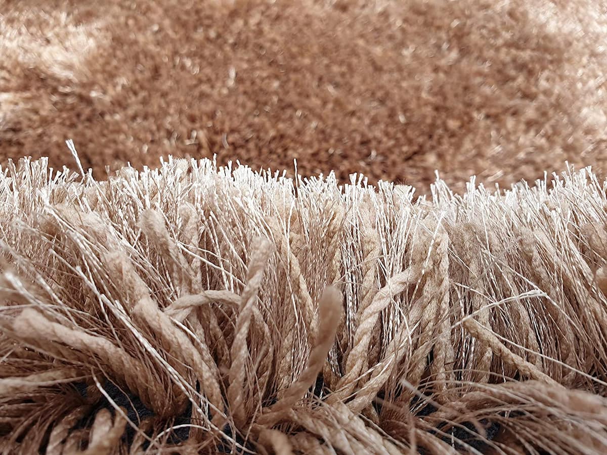 Macro view of twisted beige shag rug yarn strands - RugNoor