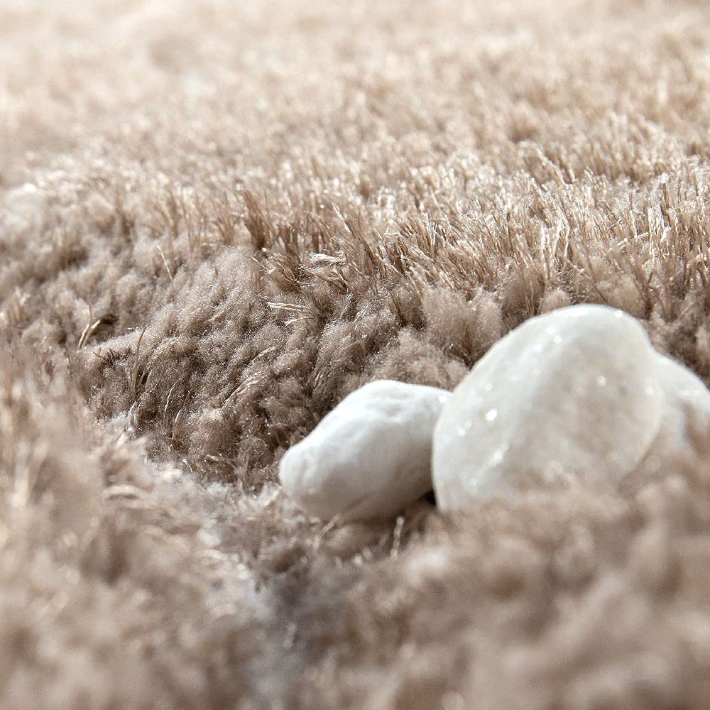 Macro shot of RugNoor's fluffy brown carpet with white stone accents