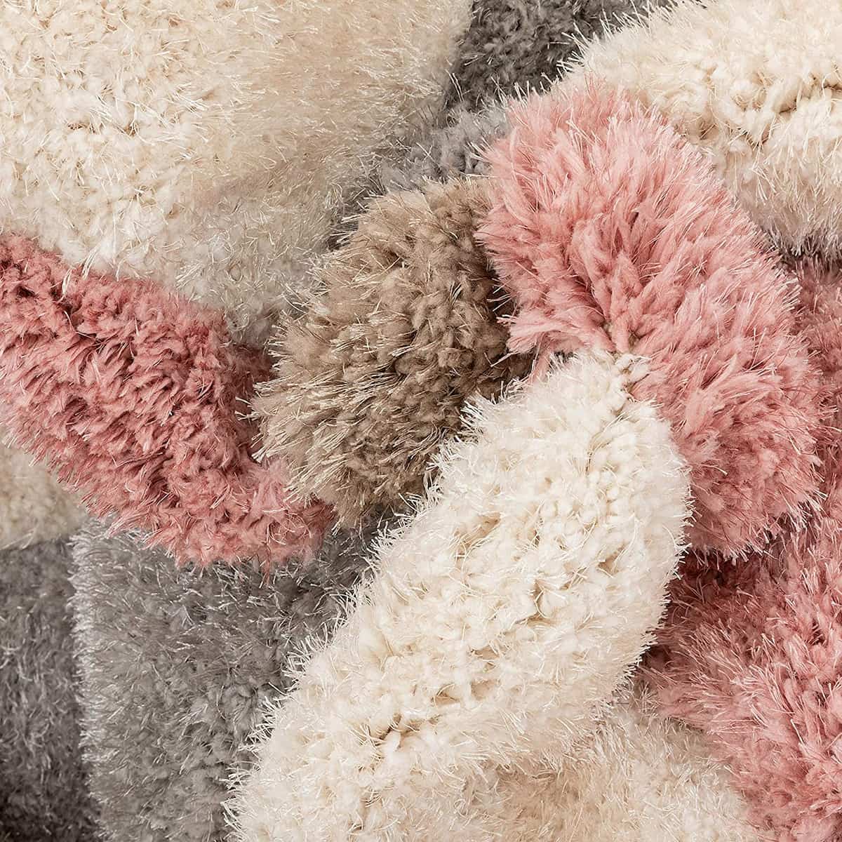 RugNoor close-up of pink, cream and grey ring pattern shag rug texture