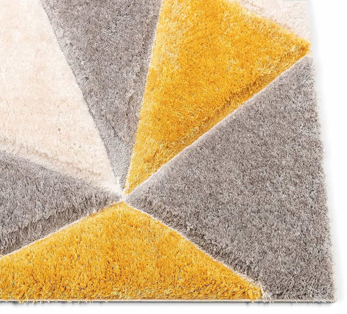 Close-up angle of RugNoor's yellow triangle print shag carpet texture